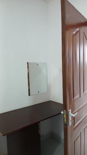 a desk with a mirror next to a door at Imani staycation Penthouse Diani in Diani Beach
