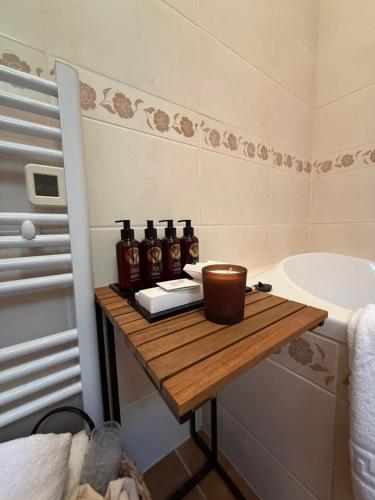 a bathroom with a wooden table with bottles on it at Deer Hill in Orahovica