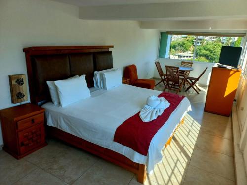 a bedroom with a large bed and a balcony at VILLA COSTERA HOTEL BOUTIQUE in Acapulco