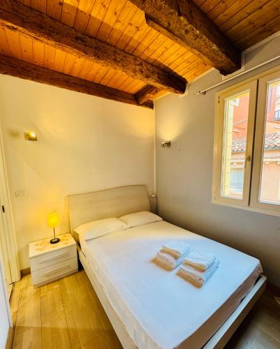 a bedroom with a bed with two towels on it at San Marco Romantic Views in Venice