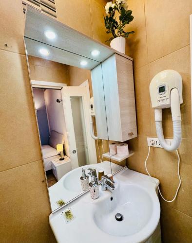 a bathroom with a sink and a mirror at San Marco Romantic Views in Venice