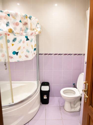 a bathroom with a tub and a toilet and a shower at Twin Double X2 Room in Istanbul