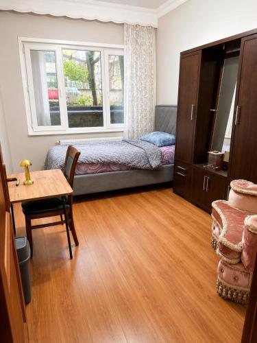a bedroom with a bed and a table and a window at Twin Double X2 Room in Istanbul