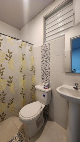 a bathroom with a toilet and a sink at Boca de Yuma Adventure in Yuma