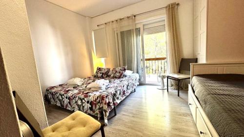 a hotel room with a bed and a window at THE Estoril Studio in Estoril