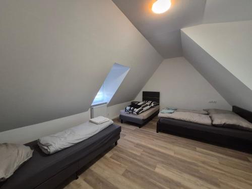 a attic room with two beds and a couch at Nektarios Bulus in Kernen