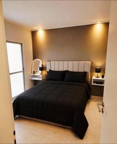 a bedroom with a large bed and a window at departamento Malbec cosecha 17 in Ciudad Lujan de Cuyo