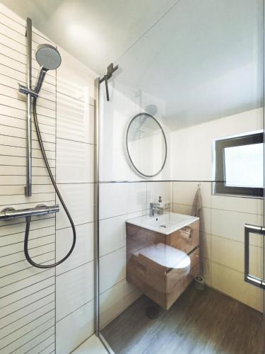 a bathroom with a sink and a mirror at Cosy Place Xanten in Xanten