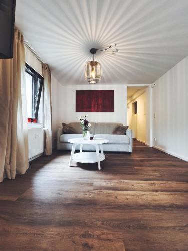 a living room with a white table and a couch at Cosy Place Xanten in Xanten