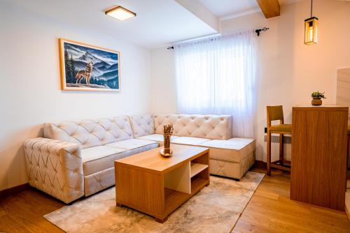 a living room with a couch and a table at Wolf Apartments Zabljak in Žabljak