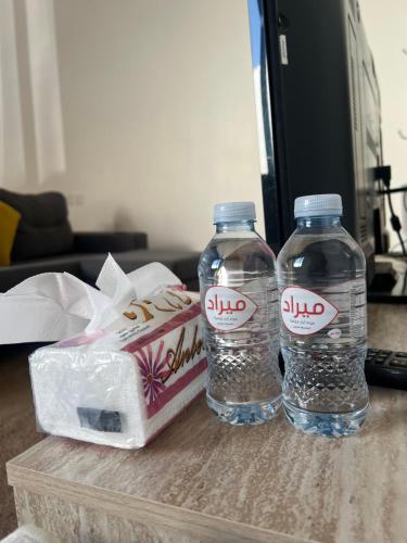two bottles of water sitting on a table at شالية ريفي الفندقي هادي وسط المدينة in Az Zulfi