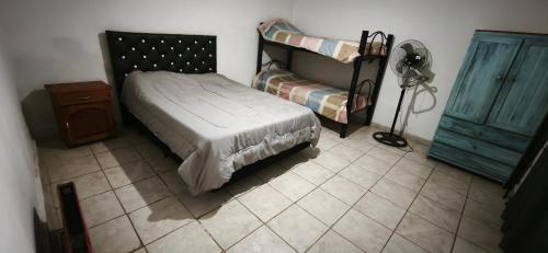 a bedroom with a bunk bed and a tiled floor at El ROBLE 2 in Córdoba