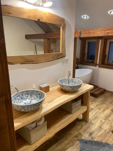 two sinks on a wooden counter in a bathroom at Chata Salamandra in Michalovce