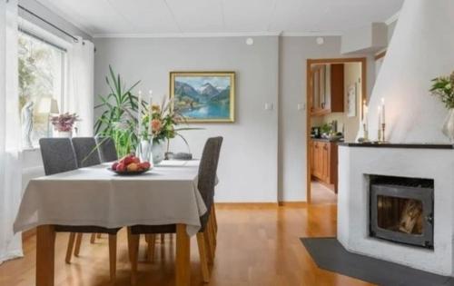 a dining room with a table and a fireplace at Villa in Gothenburg in Gothenburg