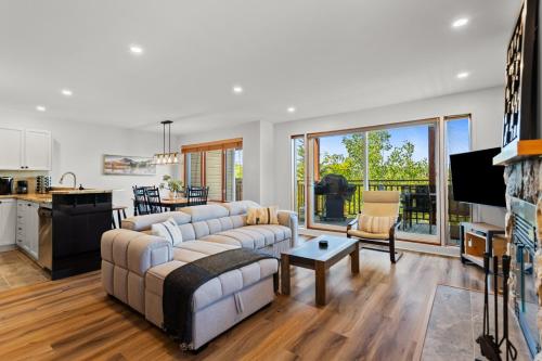 a living room with a couch and a table at Hauts-bois Ski Inout 2brs Wpool Access 193-1 in Mont-Tremblant