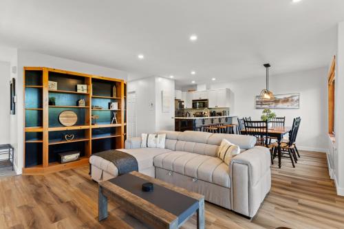 a living room with a couch and a dining room at Hauts-bois Ski Inout 2brs Wpool Access 193-1 in Mont-Tremblant