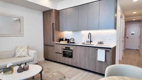 a kitchen and living room with a couch and a table at Luxury View-Walk to beach! in Miami Beach