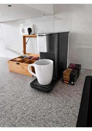 a coffee maker and a cup on a table at YourHome 2 in Haigerloch