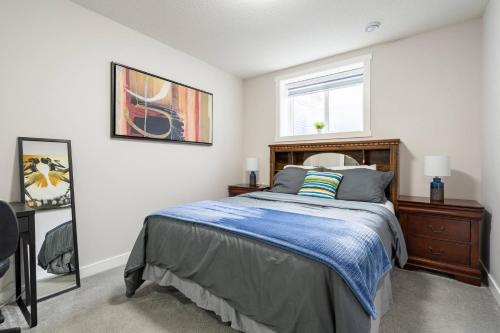a bedroom with a bed and a window at Plush Suite Pet Friendly 326 Mbps Wi-Fi in Airdrie