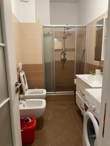 a bathroom with a shower and a toilet and a sink at Vila Konti 42 in Durrës