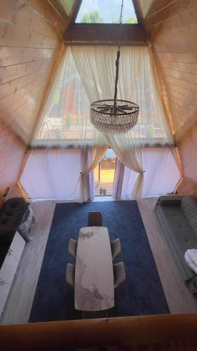 a room with a table and chairs in a yurt at Royal Park in Arslanbob
