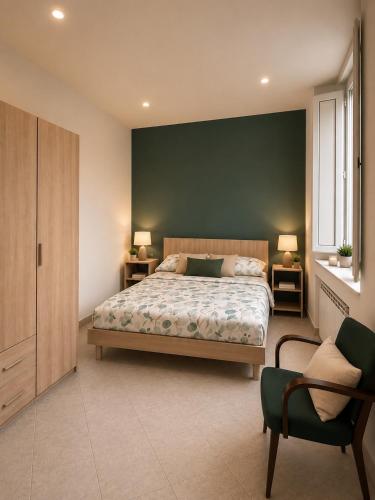 a bedroom with a bed and a green wall at L'Oasi nel Centro in Ariano Irpino