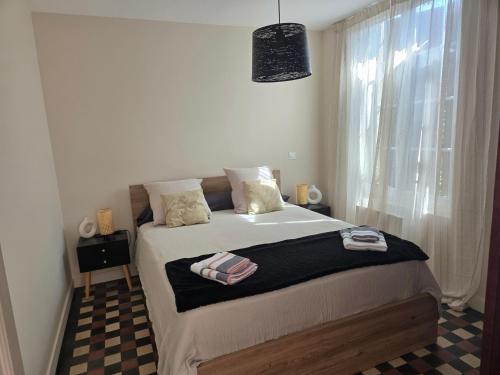 a bedroom with a bed and a window at Chez mamie in La Rochelle