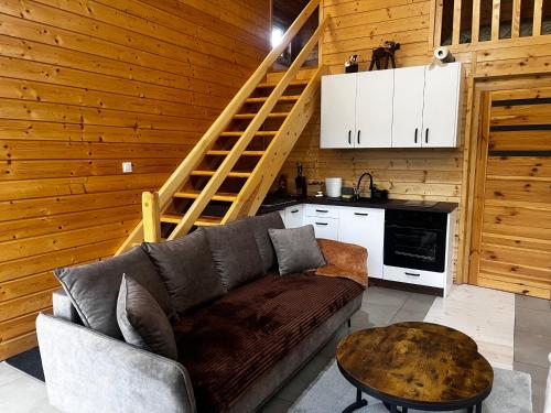 a living room with a couch and a table at W lesie nad rzeką in Rolbik