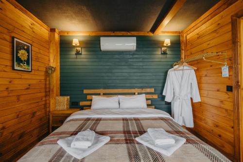 a bedroom with a bed in a wooden room at Indra Village Hotel in Pazar