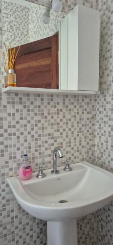 a white sink in a bathroom with a mirror at El hogarcito in Cafayate