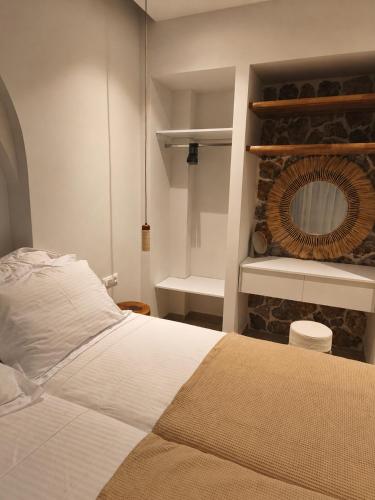 a bedroom with a white bed and a fireplace at Villa Sivo in Kolymbia