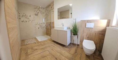 a bathroom with a toilet and a sink at Grmač Apartments in Naklo
