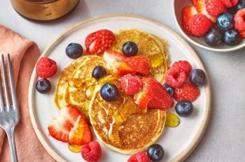 a plate of pancakes with fruit and berries on it at DELUXE OCEAN view VILLAS & Apartments with POOL - PLAYA LOS CORALES, BBQ, SPA in Punta Cana