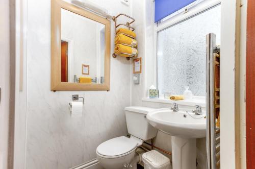 a bathroom with a toilet and a sink and a mirror at Cherish Lewis Hotel- Hull Road, Blackpool Central in Blackpool