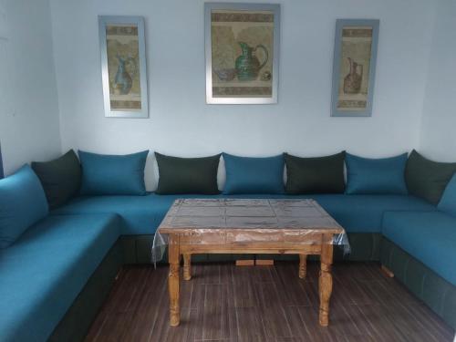 a room with blue couches and a coffee table at Casa Tanger in Tangier