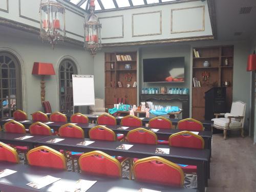a conference room with chairs and a table and a screen at Esperia Boutique Hotel in Agrinion