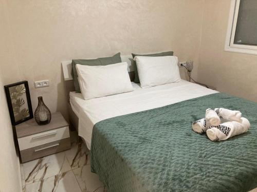 a stuffed teddy bear laying on a bed at Sable d or saidia in Saïdia