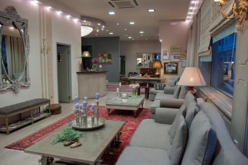 a living room with a couch and a table at Esperia Boutique Hotel in Agrinion