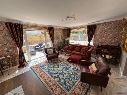 a living room with a couch and a table at Cerrig in Llangollen