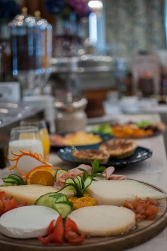 a table with plates of food on a table at Esperia Boutique Hotel in Agrinion