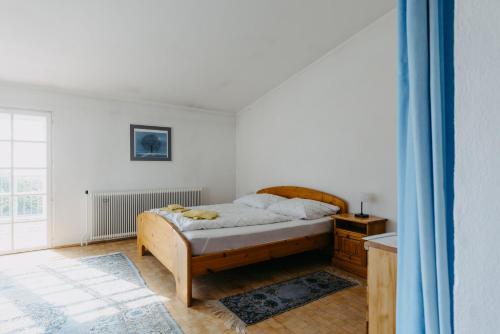 a bedroom with a bed in a room with a window at Villa Vista Pannonia in Donnerskirchen