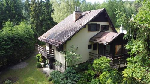 a white house with a brown roof at Na samotě u lesa in Libňatov