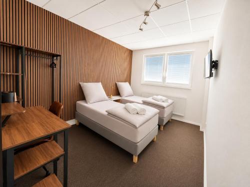 a room with two beds and a couch and a table at HanseStay Wandsbek in Hamburg