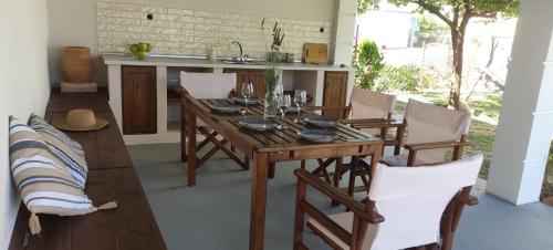 a dining room with a wooden table and chairs at Vintage Garden House in Doxato