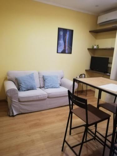 a living room with a couch and a table at Candelieri Suites in Sassari