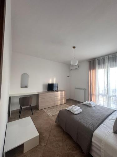 a bedroom with a bed and a desk and a television at Panorama Rooms in Gesualdo