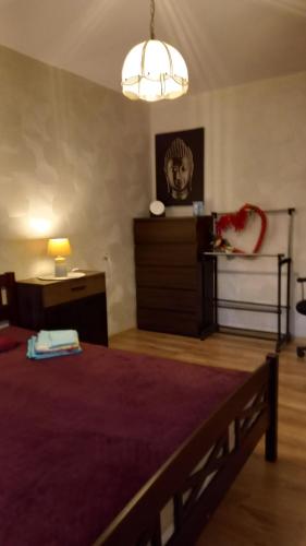 a bedroom with a bed and a lamp and a dresser at Ventspils Juras in Ventspils