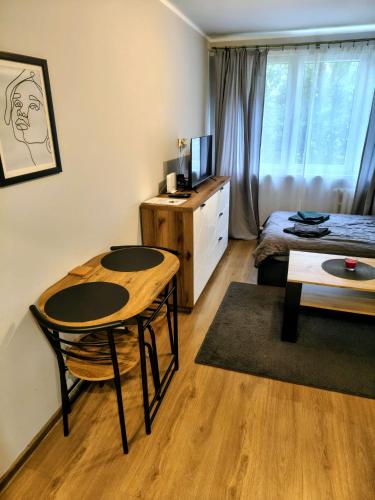 a room with a table and a bed and a desk at Na Podwalu in Jaworzno