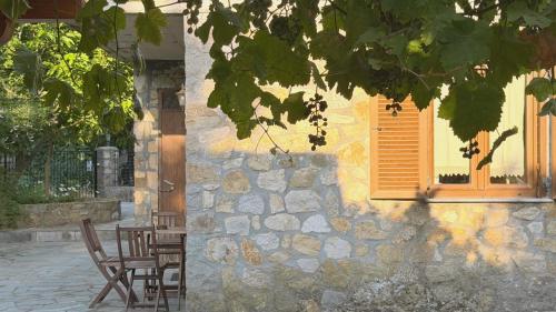 a building with a table and chairs and a window at Kyveli Homes in Therma