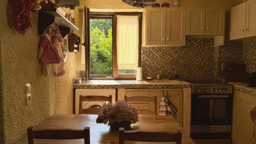 a kitchen with a table and a window at Kyveli Homes in Therma